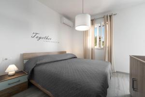 a bedroom with a bed and a pendant light at Astrid 2 in Rabac