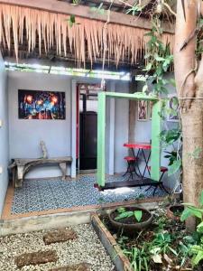 a patio of a house with a table and a bench at Artist's Place Trat in Trat