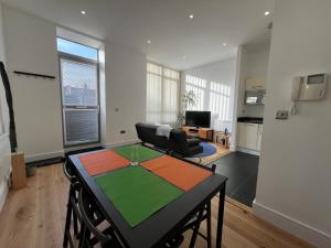 a living room with a table and a couch at Delightful & Spacious Flat in London - Peckham in London