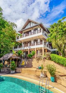 a house with a swimming pool in front of it at 3 Bedroom Villa Cara SDV042-By Samui Dream Villas in Mae Nam