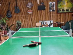 a ping pong table with two bats on top of it at Los Tres Leones in Salento