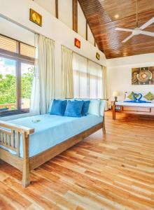 a bedroom with a large bed with blue pillows at 3 Bedroom Villa Cara SDV042-By Samui Dream Villas in Mae Nam +24 photos
