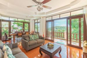 a living room with a couch and a table at 3 Bedroom Villa Cara SDV042-By Samui Dream Villas in Mae Nam