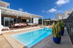 a swimming pool in a house with a patio at Villa Golf Lanzarote in Costa Teguise