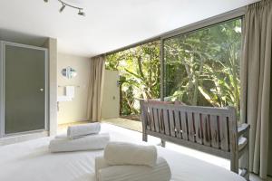 a bedroom with a bed and a large window at The Grange 11 in Cape Town