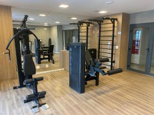 a gym with treadmills and exercise equipment in a room at Studio Metrô Brooklin in Sao Paulo