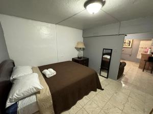 a bedroom with a bed and a room with a lamp at 1BR Plus Basement, Near Beach and Restaurants in San Juan
