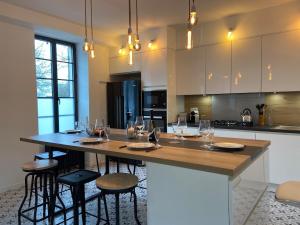 a kitchen with a large island with wine glasses on it at Casa 64 in Angers