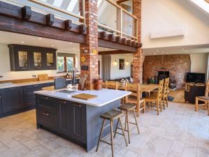 an open kitchen and dining room with a table and chairs at Brambleberry Barn in Spilsby