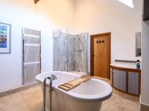 a large bathroom with a tub and a shower at Brambleberry Barn in Spilsby