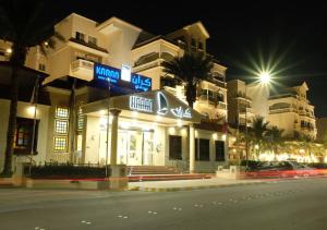 a building on a street corner at night at Karan Hotel in Al Jubail
