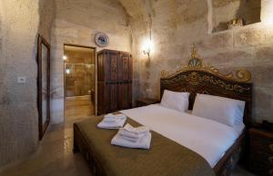 a bedroom with a bed with towels on it at Capp Royal Cave HOTEL in Urgup