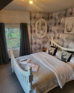 - une chambre avec un grand lit blanc dans l'établissement Babbling Brook Guesthouse, à Keswick