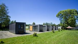 a row of modular homes in a field of grass at Obytný kontejner in Roudná
