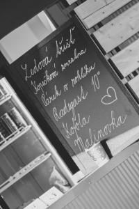 a chalkboard with writing on it on a table at Obytný kontejner in Roudná