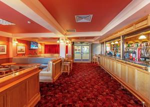 a restaurant with a bar with a red carpet at Stanwix Park in Silloth +80 photos