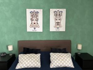 a bedroom with three posters on the wall at Residenza Parco Gioeni in Catania