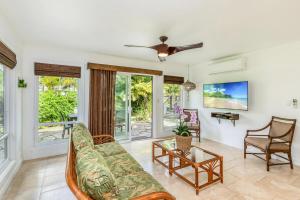 a living room with a couch and a ceiling fan at Luana Hale in Princeville