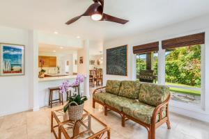 a living room with a couch and a kitchen at Luana Hale in Princeville