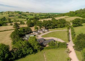 an aerial view of a house in a field at Andrewshayes Orchard Retreat in Axminster