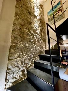 a stone wall with a staircase in a room at PESCULUM nel borgo in Pescocostanzo