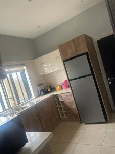 a kitchen with a door in the middle of a room at Luxe Living:4Bed, TV, Pool& WiFi in Lekki