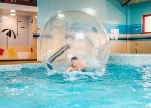 a man in an inflatable ball in a swimming pool at Thurston Manor in Innerwick