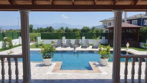 a view of a pool with chairs in a house at Villa Vanilya in Dalyan