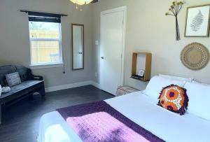 a bedroom with a bed with a pillow on it at Quiet, Cozy Guesthouse with privacy in Manvel
