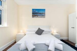 a white bedroom with a large bed with white furniture at Property 444 - Clifden in Clifden