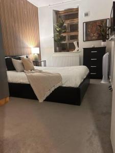 a bedroom with a large bed and a window at Quirky Hackney Wick 1 bed Flat! in London