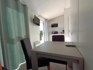 a kitchen with a table and chairs in a room at Gasthof Sonnenterrasse - 24h Self-Check-in in Litzelsdorf