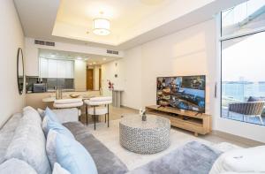 sala de estar con sofá y TV en New Arabian MINA By Azizi With Private Beach & Sea View 606, en Dubái