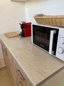 a kitchen counter with a microwave on top of it at Thalassa in Monodhéndrion