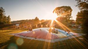 a group of people riding skateboards on a ramp in a park at Obytný kontejner in Roudná