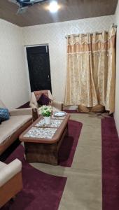 a living room with a couch and a coffee table at Luminaire Homestay in Srinagar