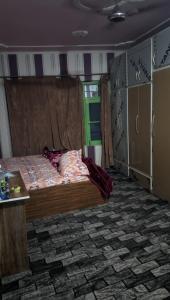 a bedroom with a large bed in a room at Luminaire Homestay in Srinagar