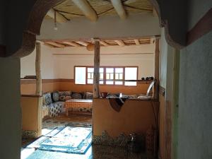 a living room with a couch in the middle of a room at riad jnane imnane in Tamguist