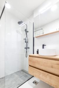 a bathroom with a sink and a shower at Arvia Apartment in Zagreb