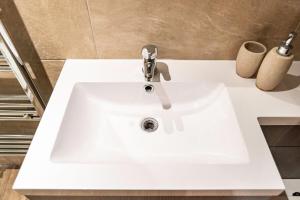 a white sink with a faucet in a bathroom at Camden Apartments 1 in Liverpool +4 photos