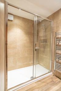 a shower with a glass door in a bathroom at Camden Apartments 1 in Liverpool