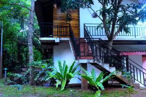 a house with a staircase leading up to it at Wild Heaven Udawalawe in Udawalawe