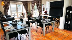 a living room with a table and some chairs at Plattekloof Premium Lodge in Plattekloof