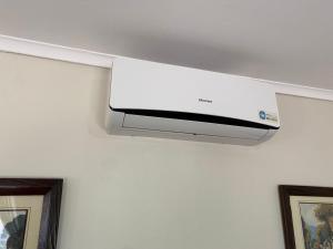 - un climatiseur blanc suspendu au plafond dans l'établissement Cosy 3 bedroom cottage - 2034, à Kingsmead
