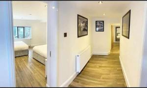 a hallway leading to a bedroom with a bed at Camden Apartments 2 in Liverpool
