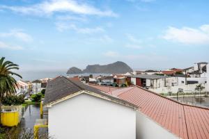a view of a town with a mountain in the background at Casa São Pedro in Vila Franca do Campo