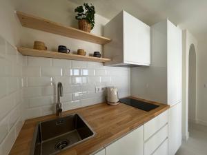 a kitchen with a sink and wooden counter top at BLUE HORIZON Morro Jable in Morro del Jable