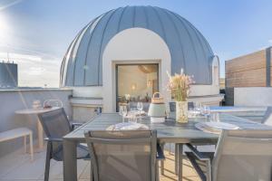 a dining table and chairs on a balcony at Yuna Porte-Maillot - ApartHotel in Paris