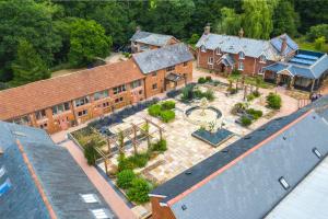 an aerial view of a large brick building with a courtyard at Ivy Cottage - Great Houndbeare Farm Holiday Cottages in Aylesbeare