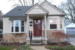 a small house with a red door at Charming, Central, Cozy Home - Ideal in Dearborn Heights